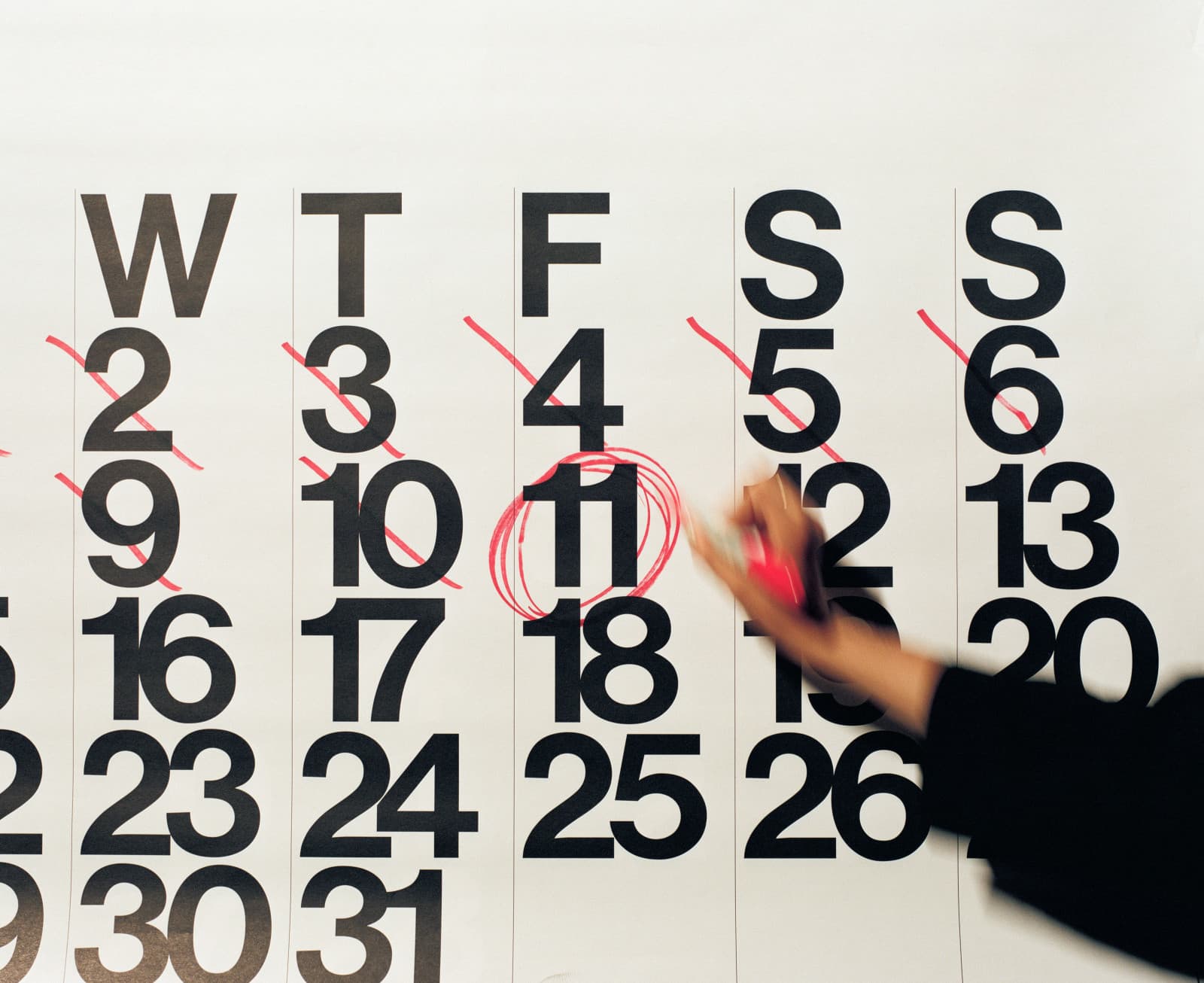 A wall calendar with a date circled in red marker