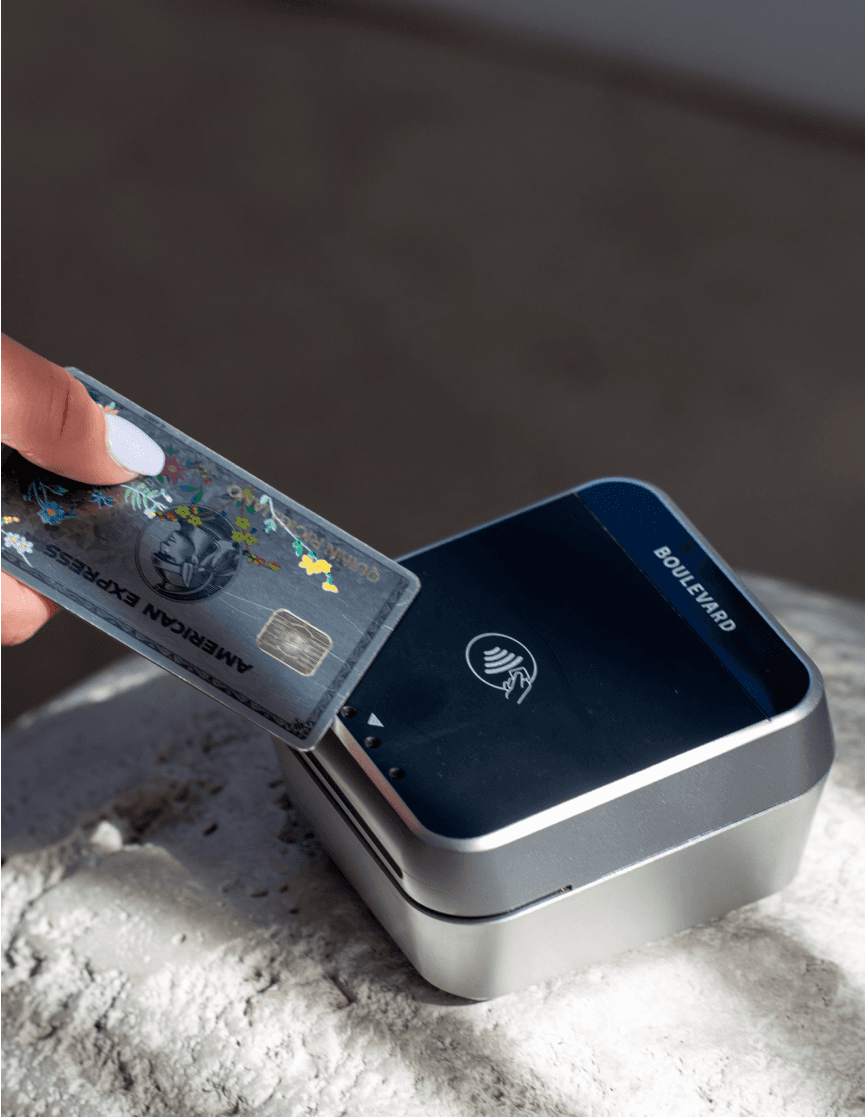 A client tapping a card on a Boulevard card reader