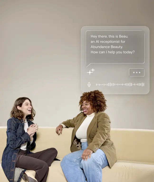 Two women laughing together on a couch while Beau answers a call in a floating chat overlay