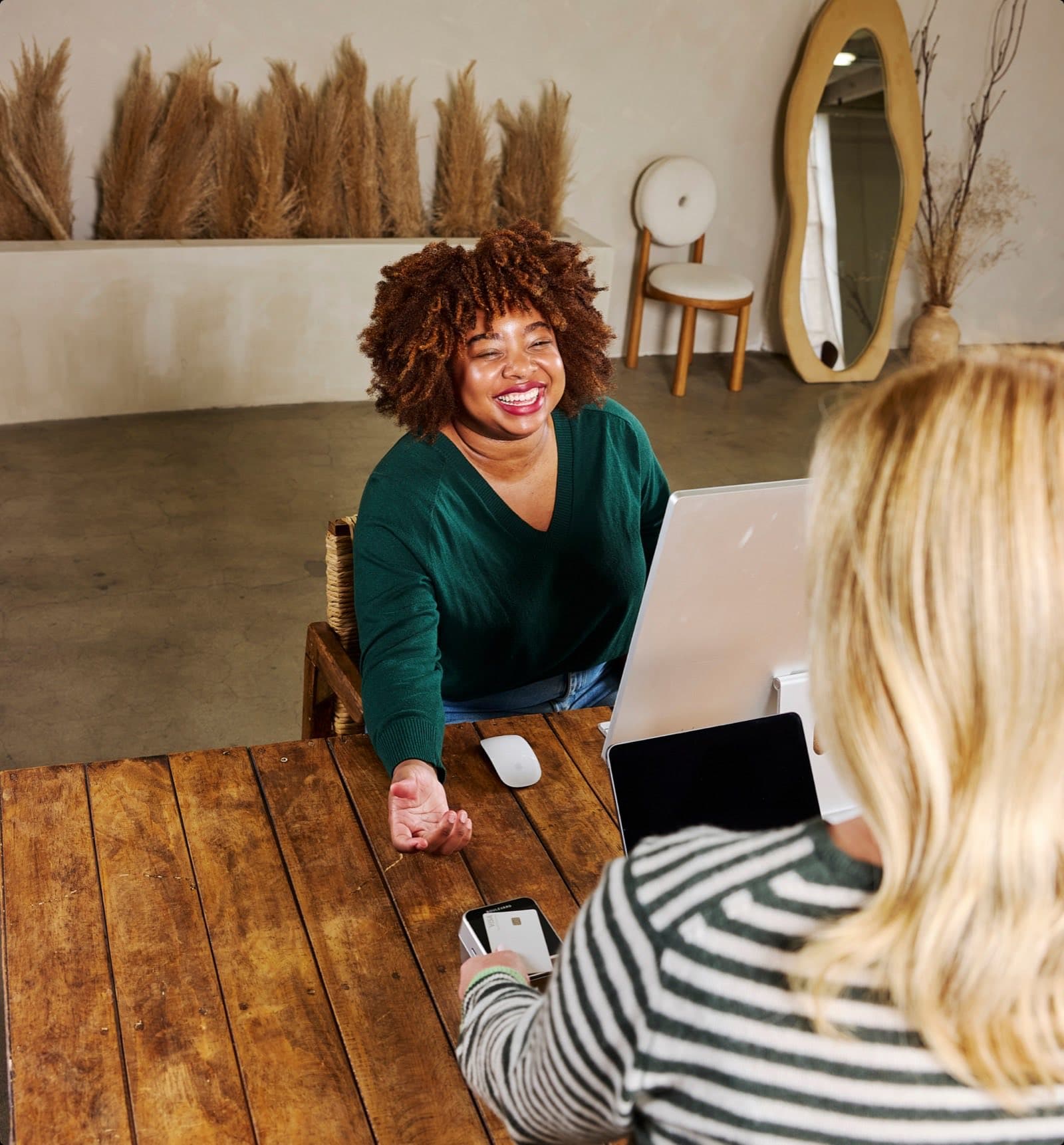 A front desk team member checking out a smiling client