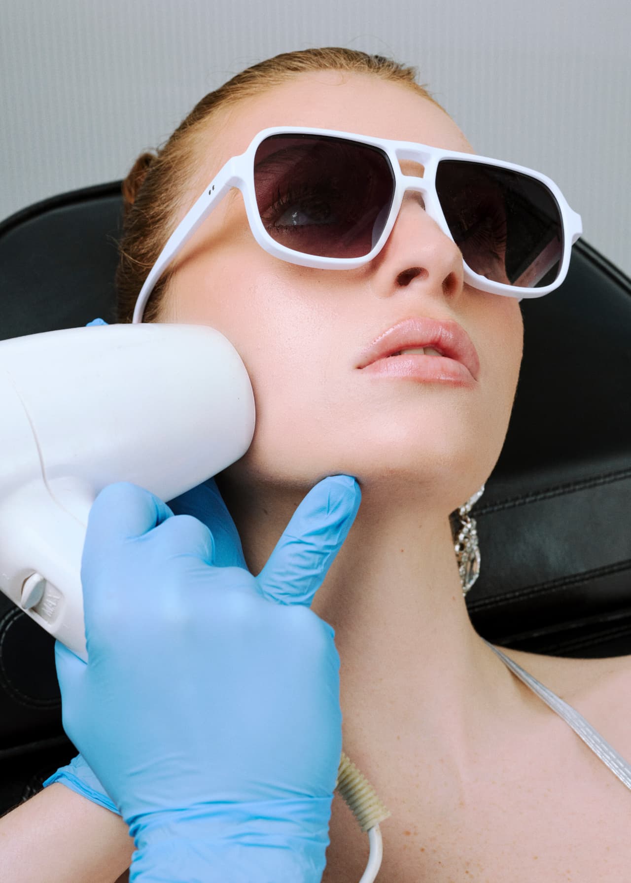 A provider performing a laser treatment on a client