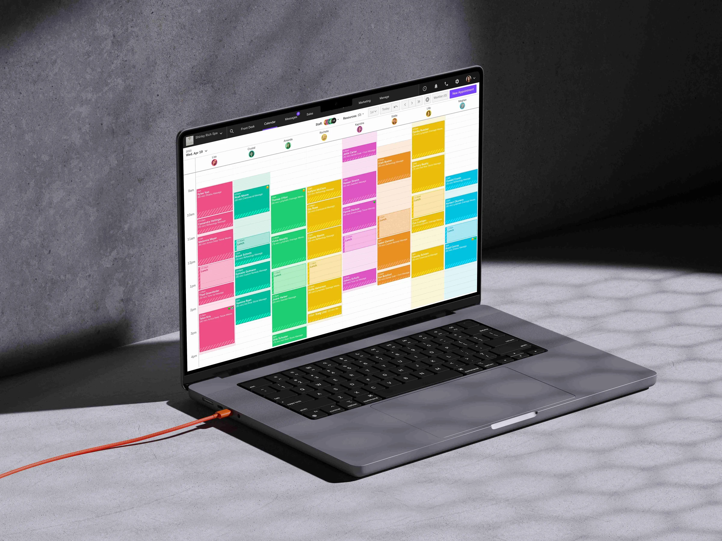 Laptop showing the Boulevard calendar with a color-coded column of massage appointments for each therapist and a New Appointment button