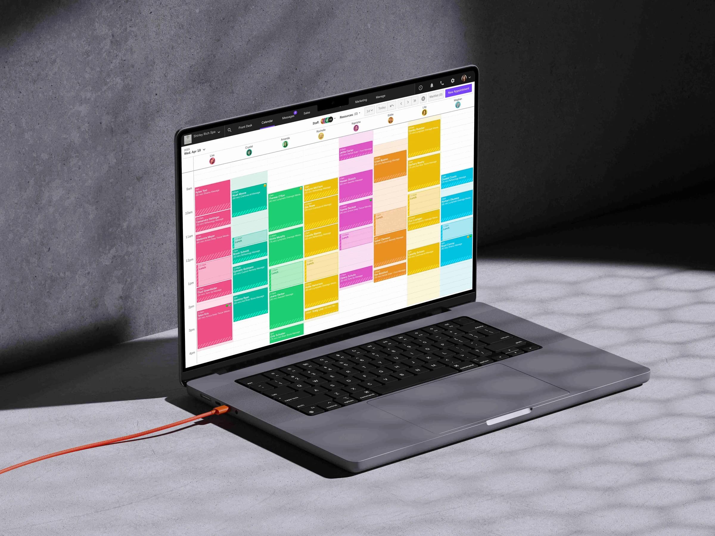 Laptop showing the Boulevard calendar with a color-coded column of massage appointments for each therapist and a New Appointment button