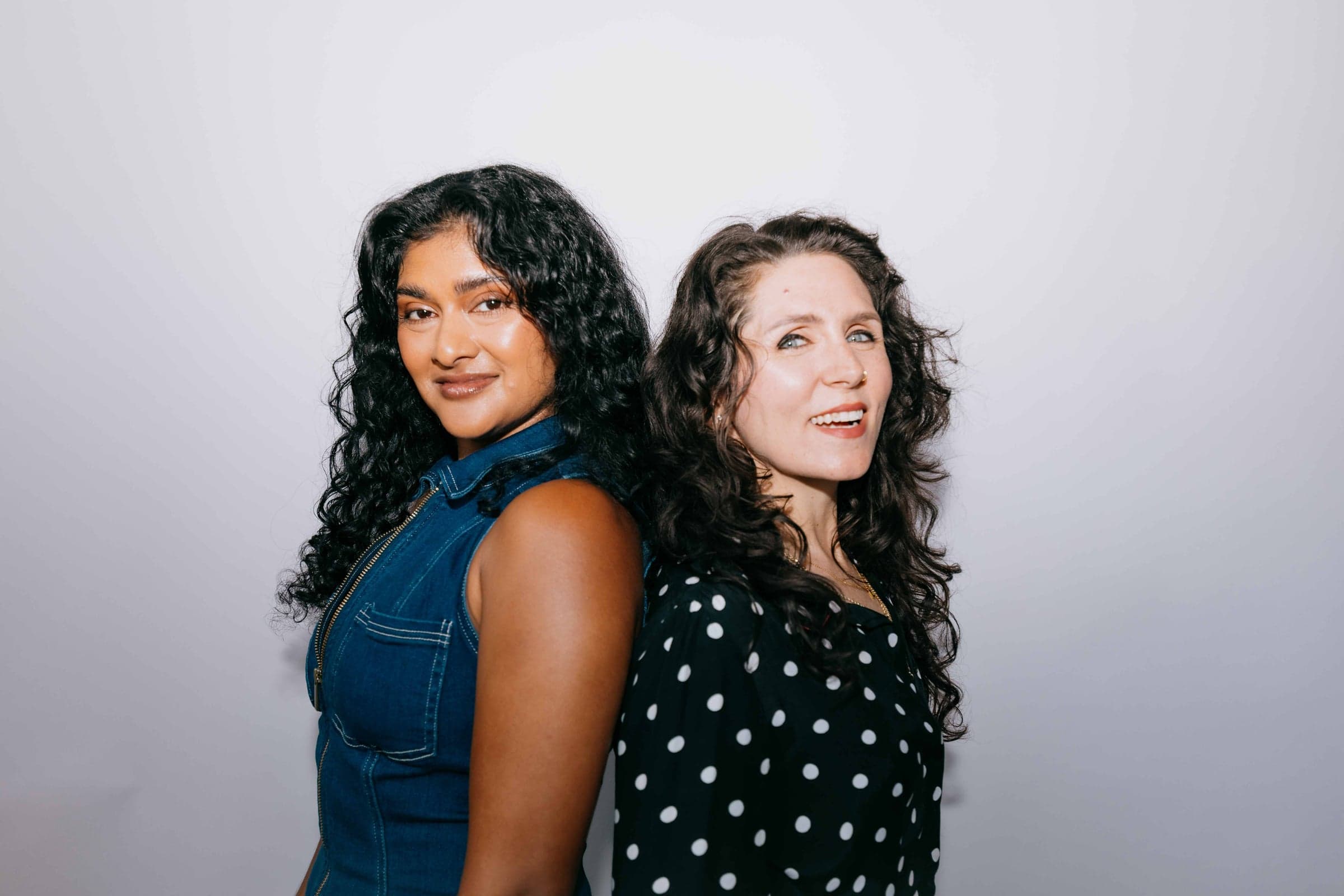 Two Hairroin Salon team members standing back to back