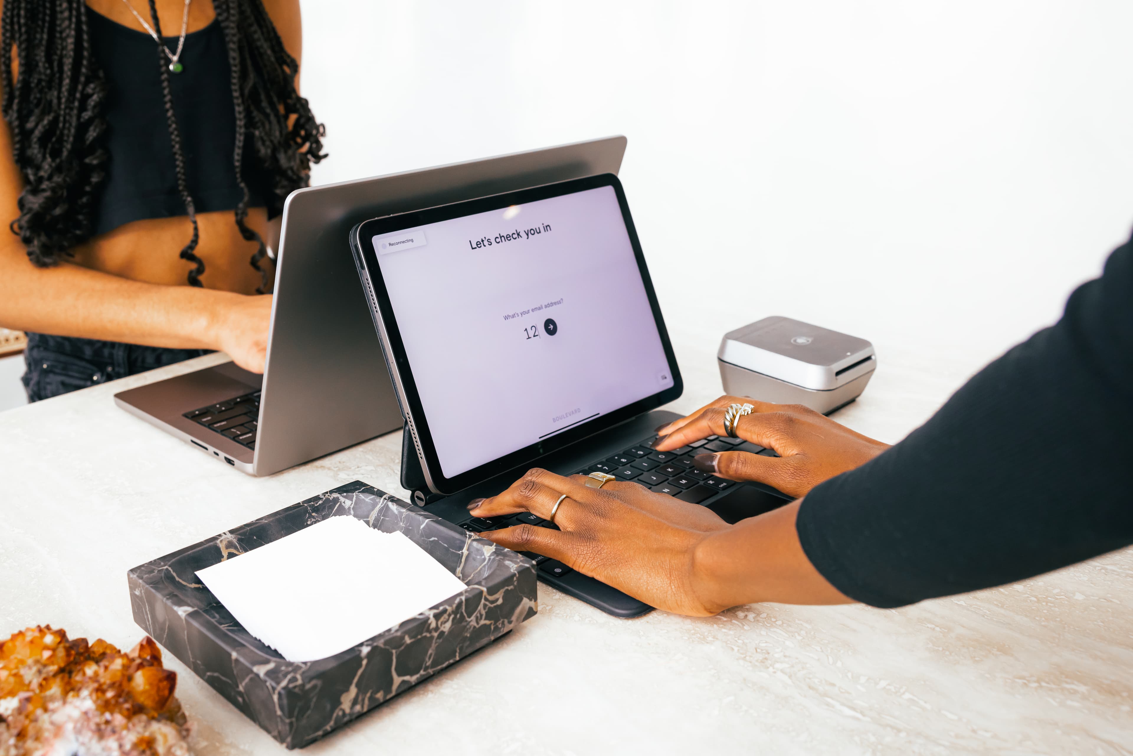 A client checks-in at a reception desk.