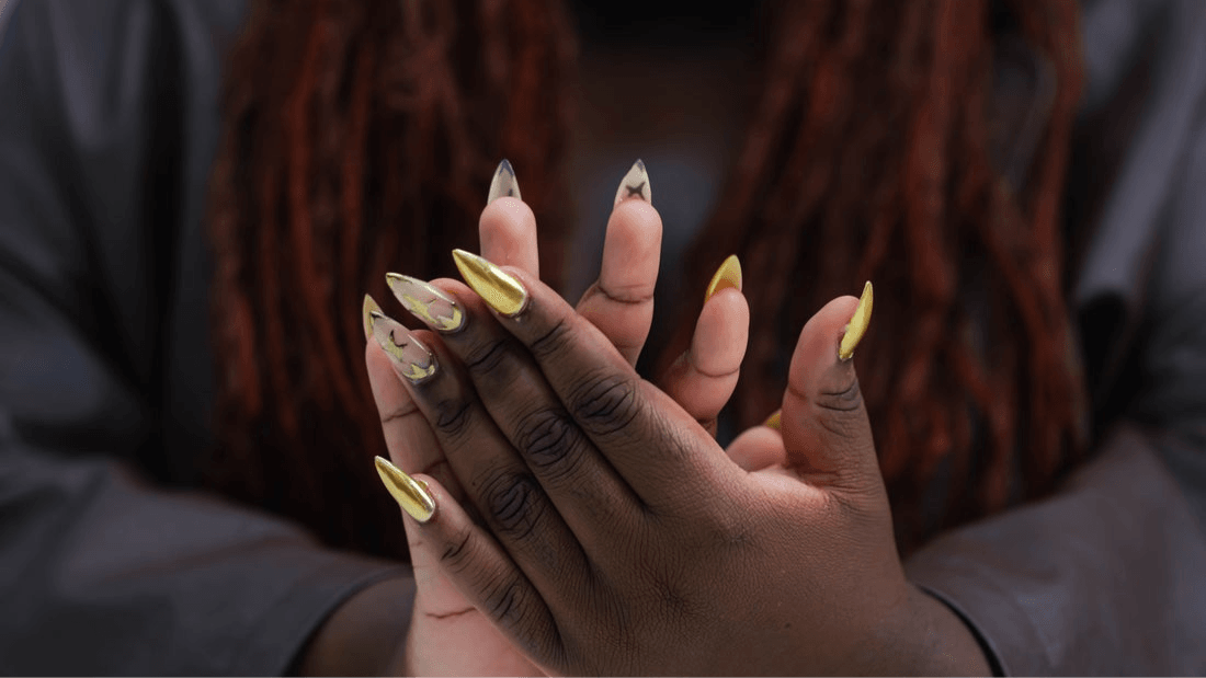 A woman shows off her manicured, painted nails.
