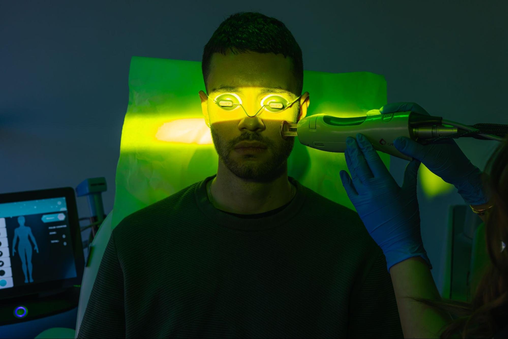 A man receives laser treatment to his cheek.