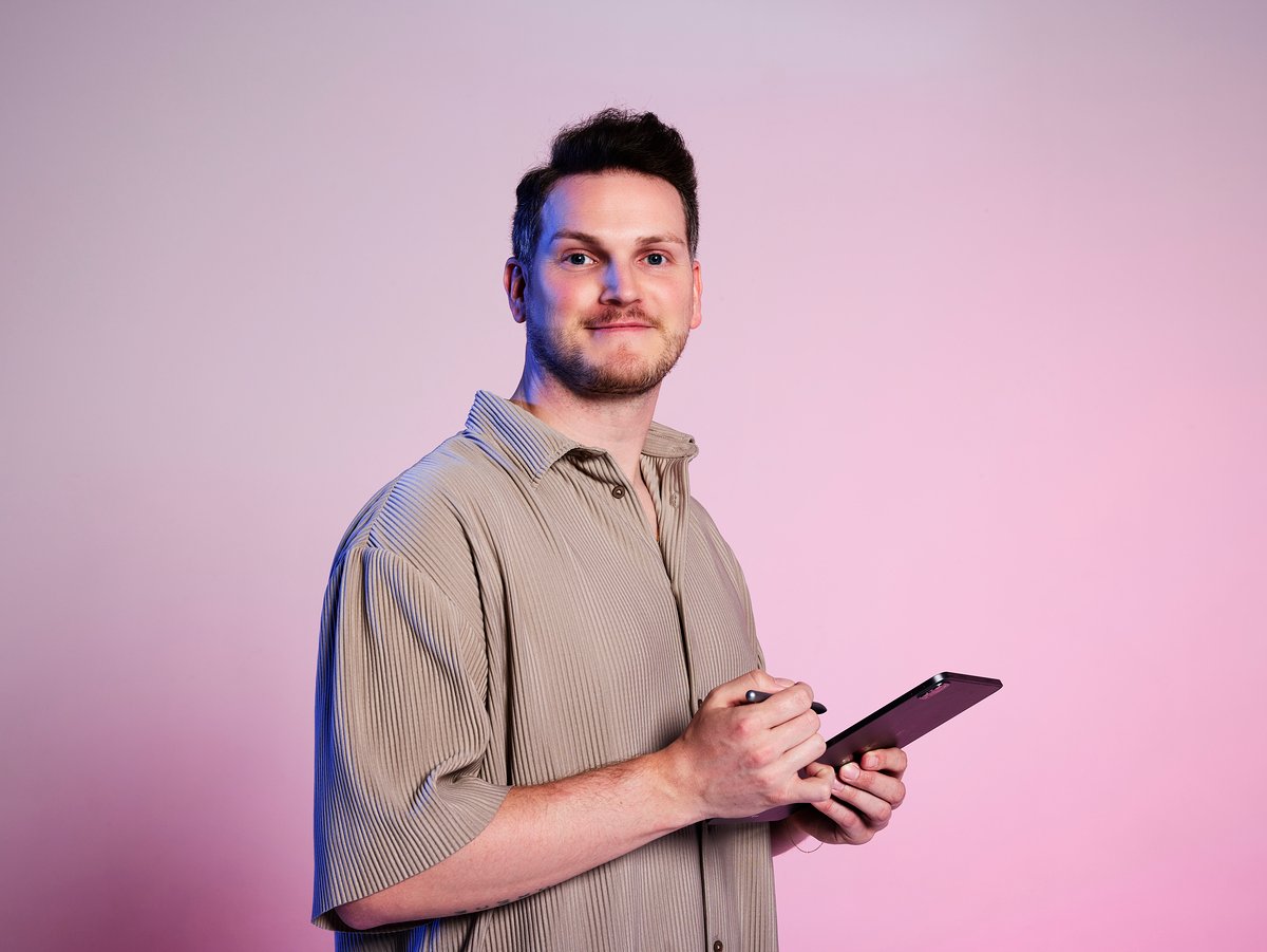 A salon owner reviews scheduling software on a tablet.