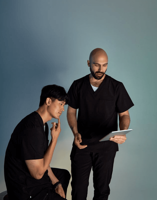 Two men looking at a tablet.