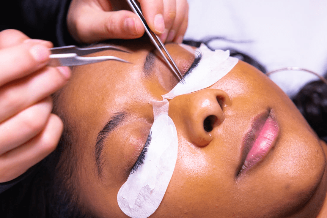 Woman receiving an eyelash extension treatment.