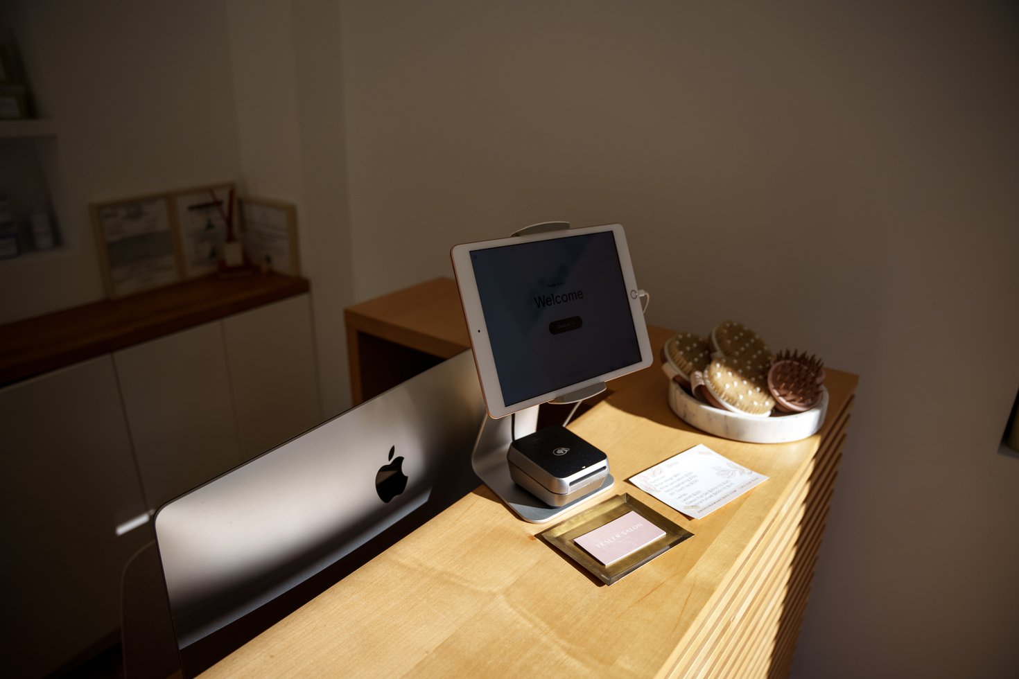 A point-of-sale system rests on a counter at a barbershop.