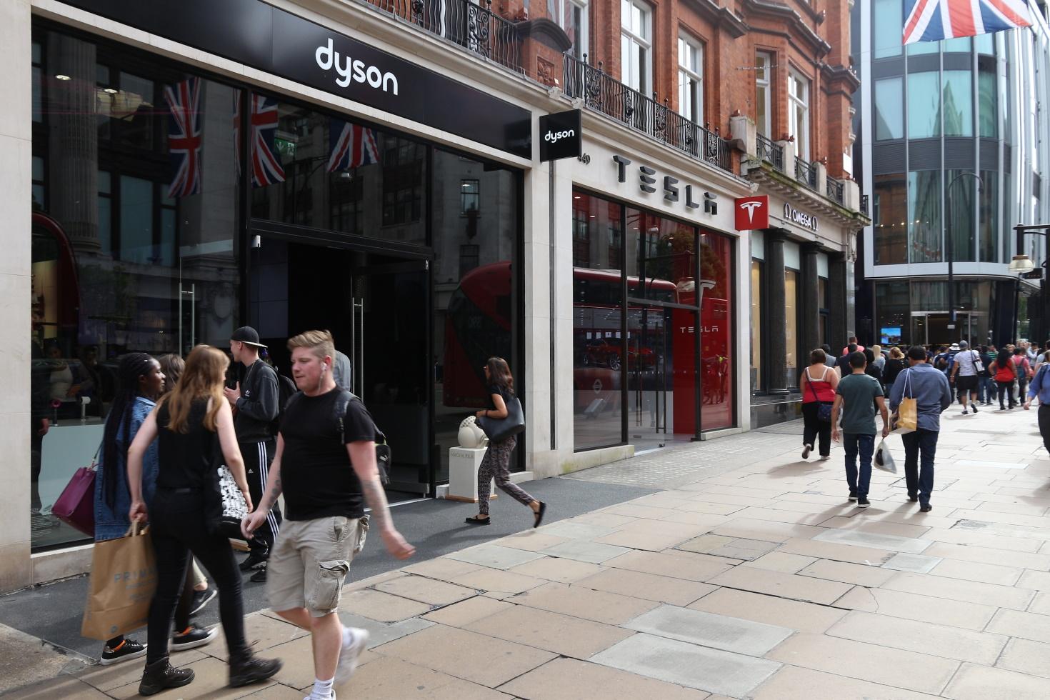 People on the street walk past a Dyson storefront