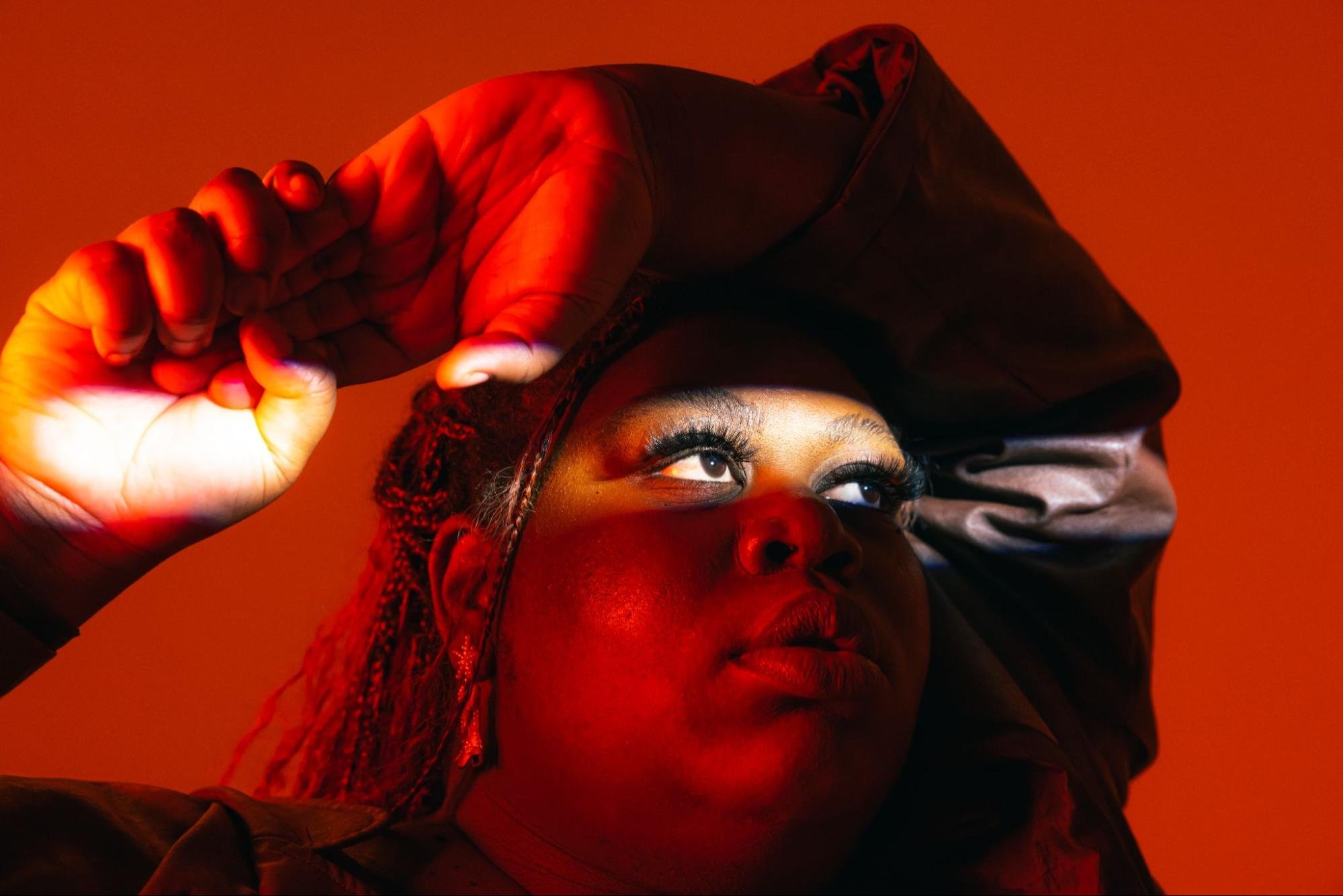 A woman in a red-tinted room