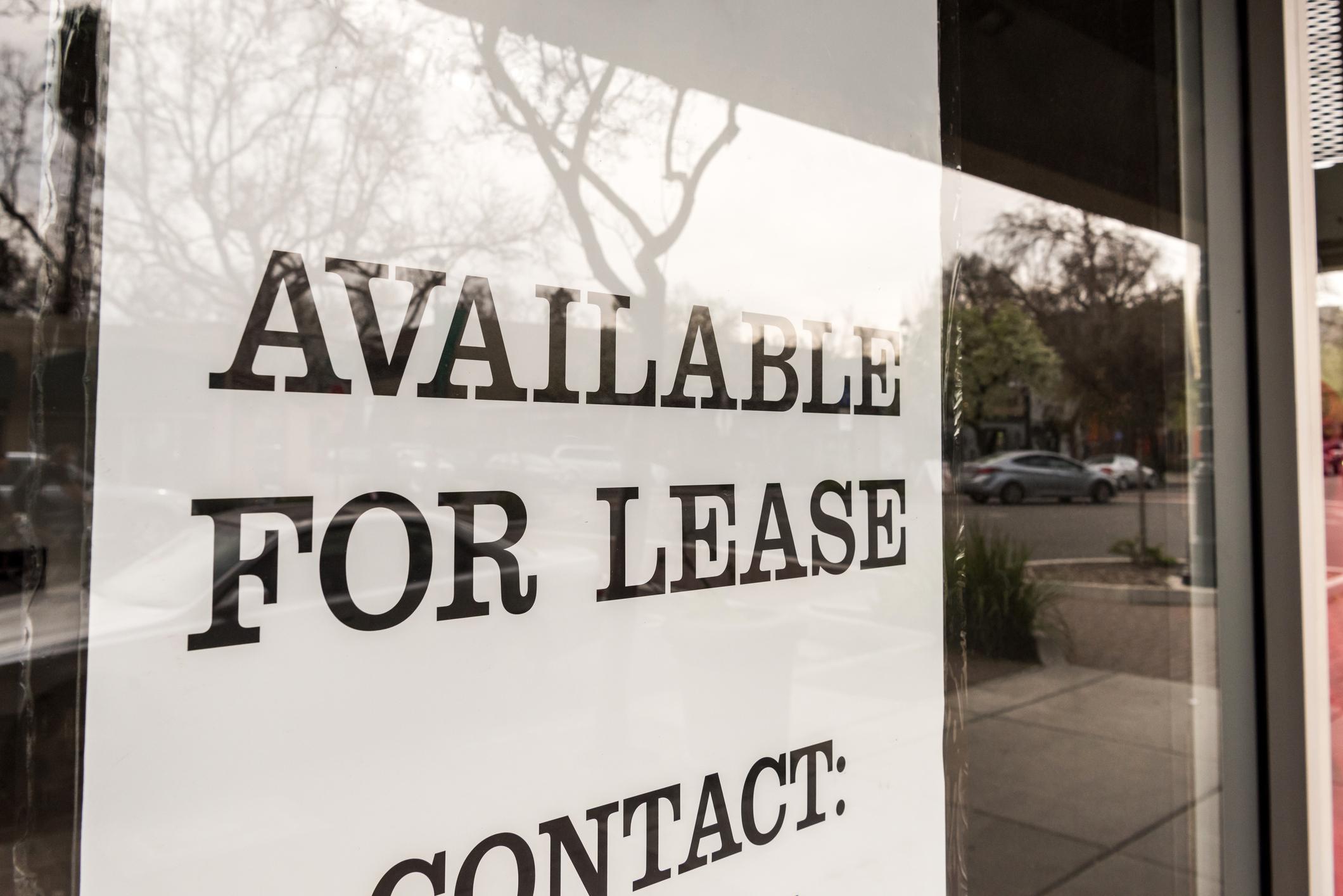A sign in a window reads, "Available for lease. Contact:"