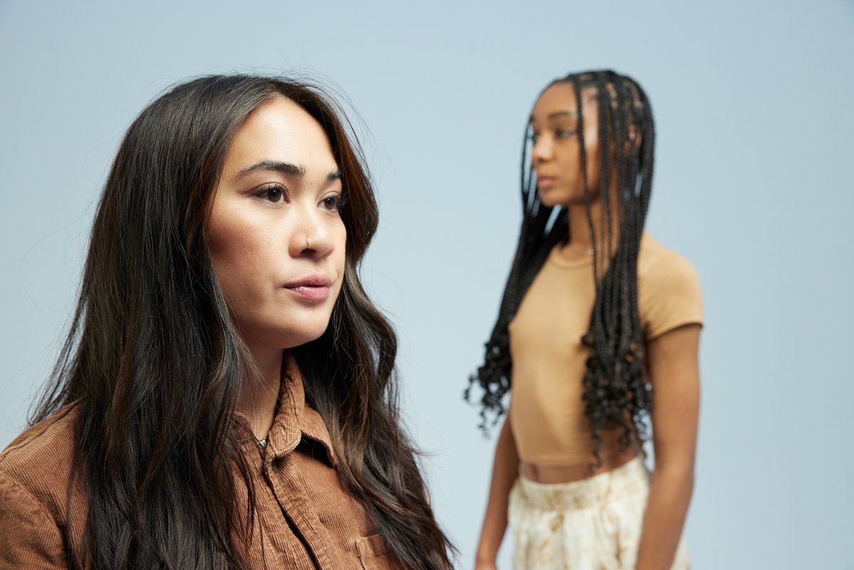 Two gen-z self-care clients facing the opposite direction, staring into the distance.